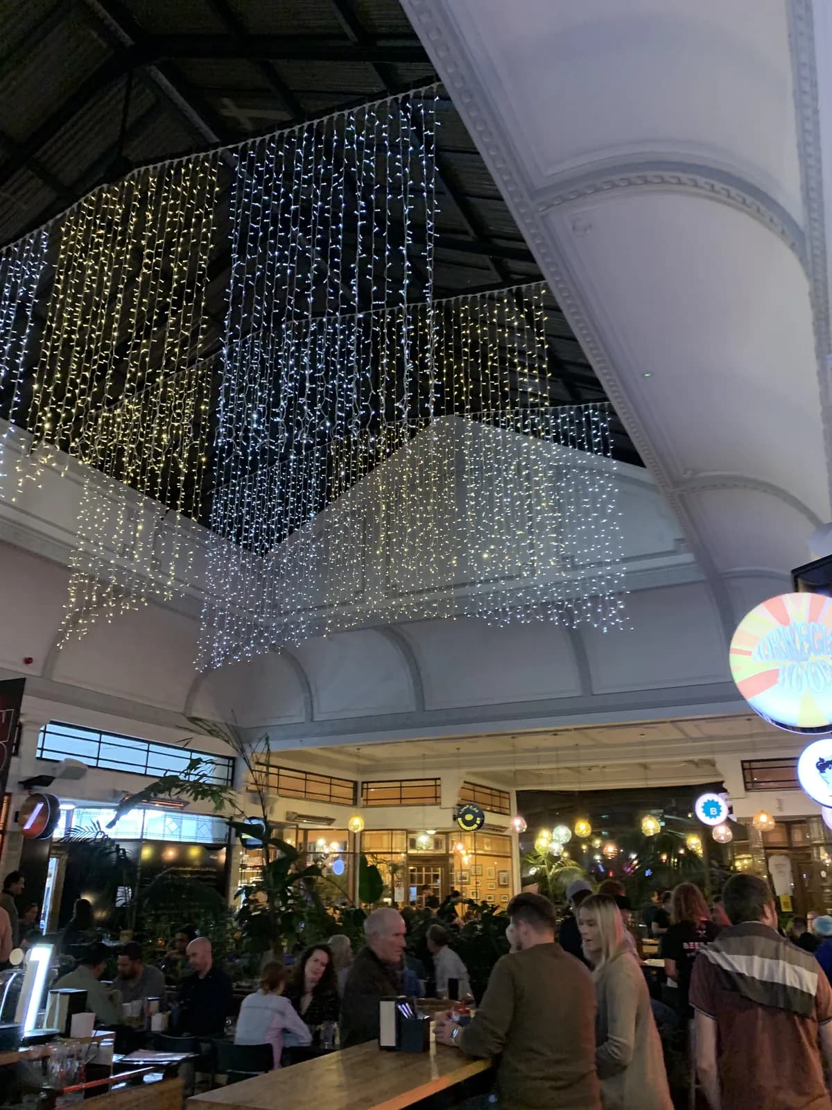 Thousands of fairy lights cascade from the ceiling of the K Road food hall